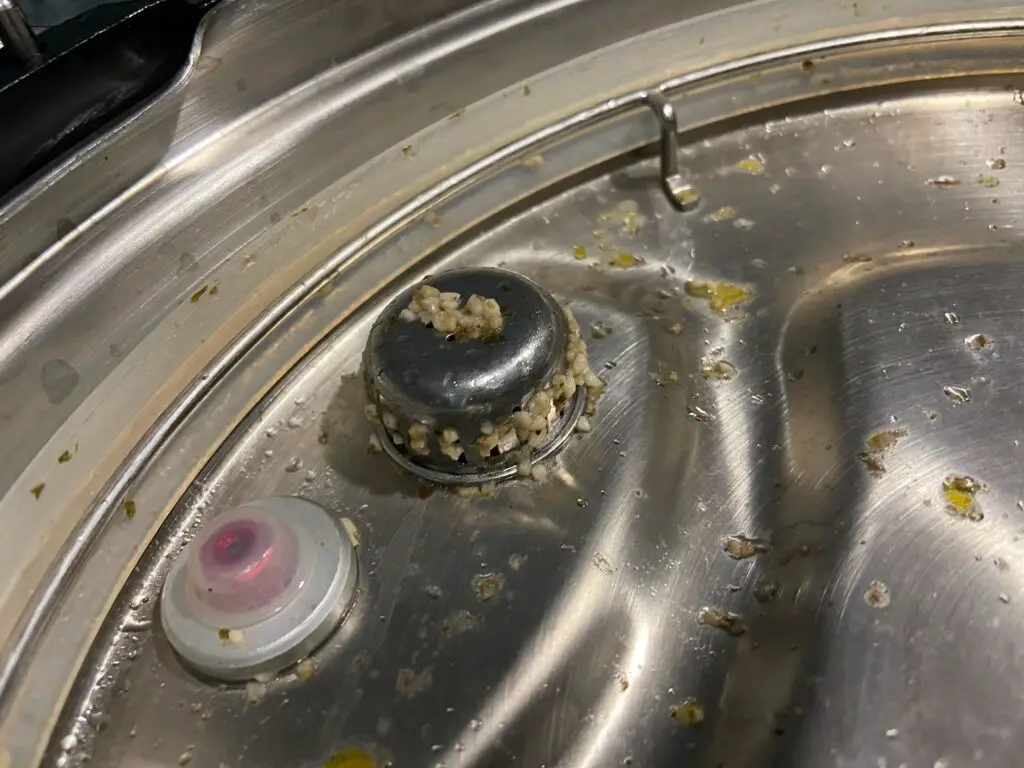 A clogged anti-block shield on an Instant Pot.